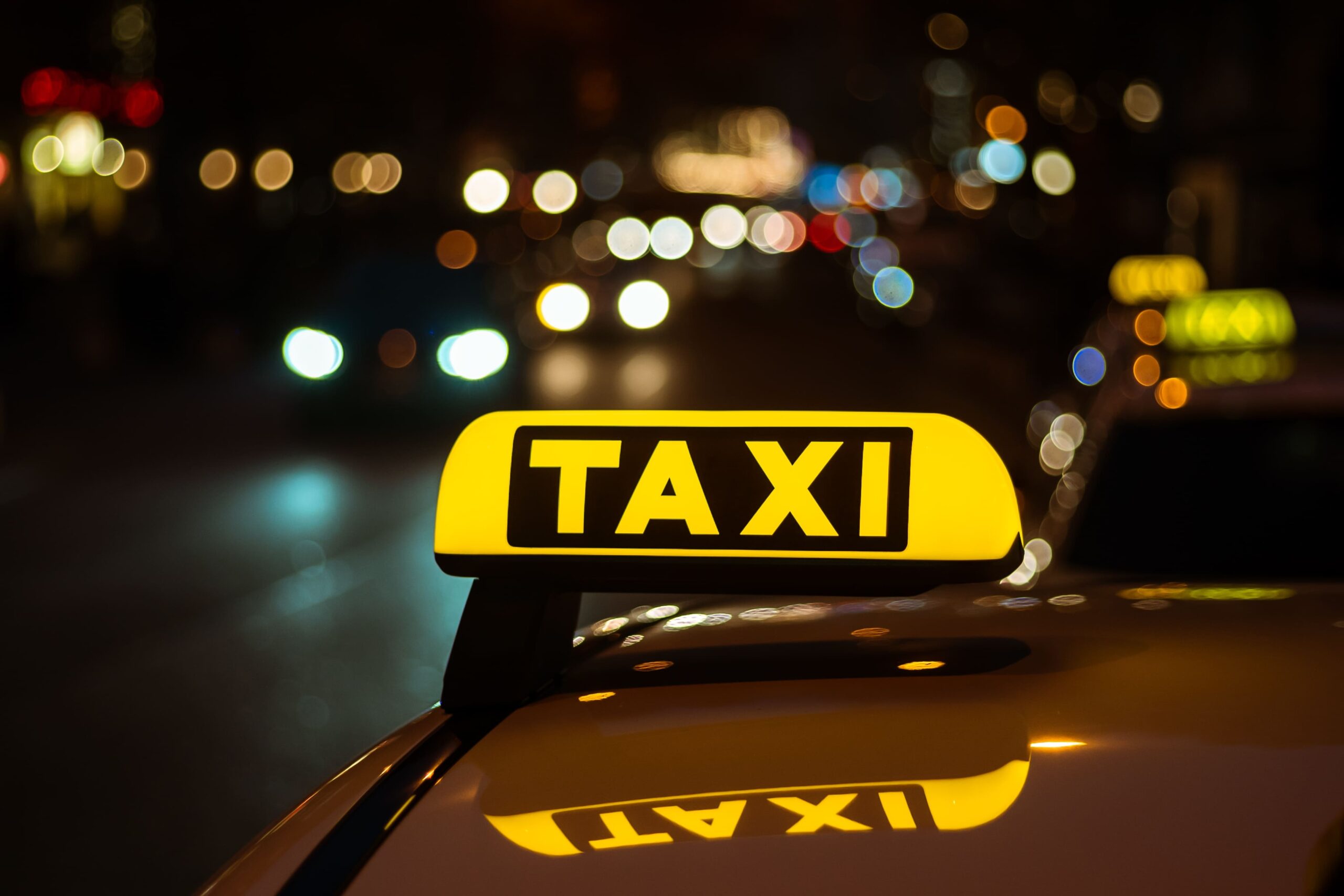 Iconic taxi sign atop cab, signaling availability for passengers.