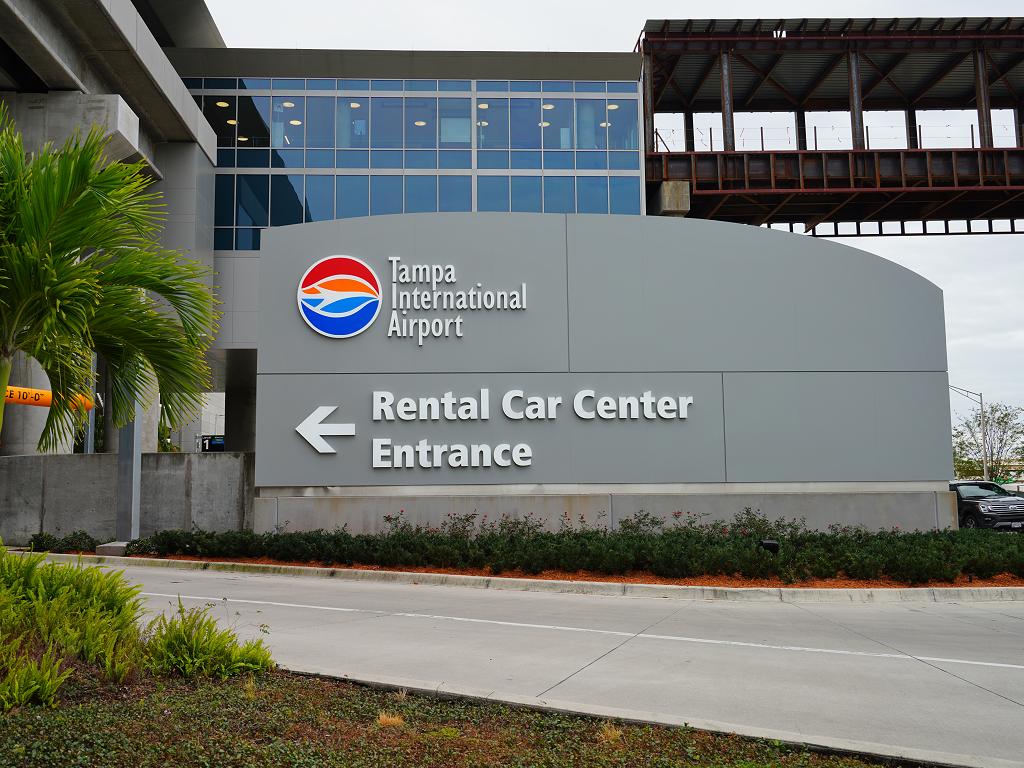 Clear sign marking entrance to rental car center to Tampa International Airport