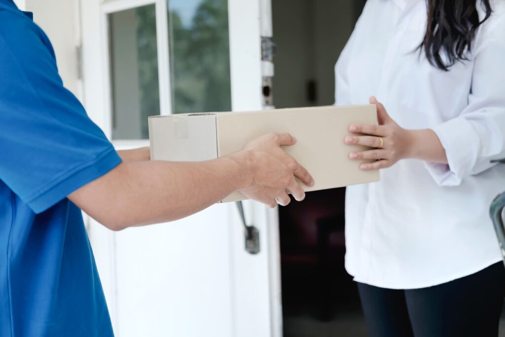 A man handing a woman a box.