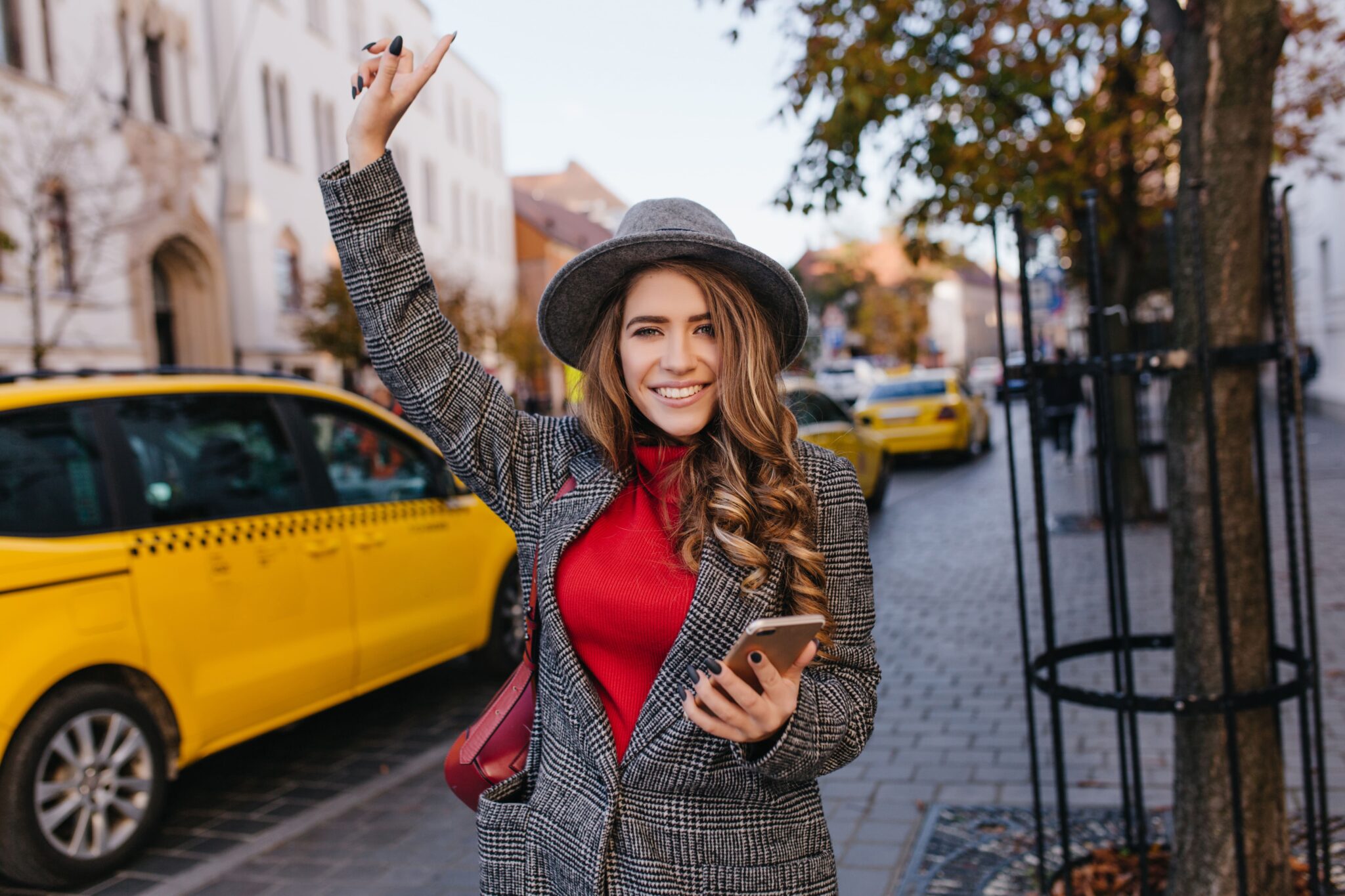 A woman in a stylish hat and coat