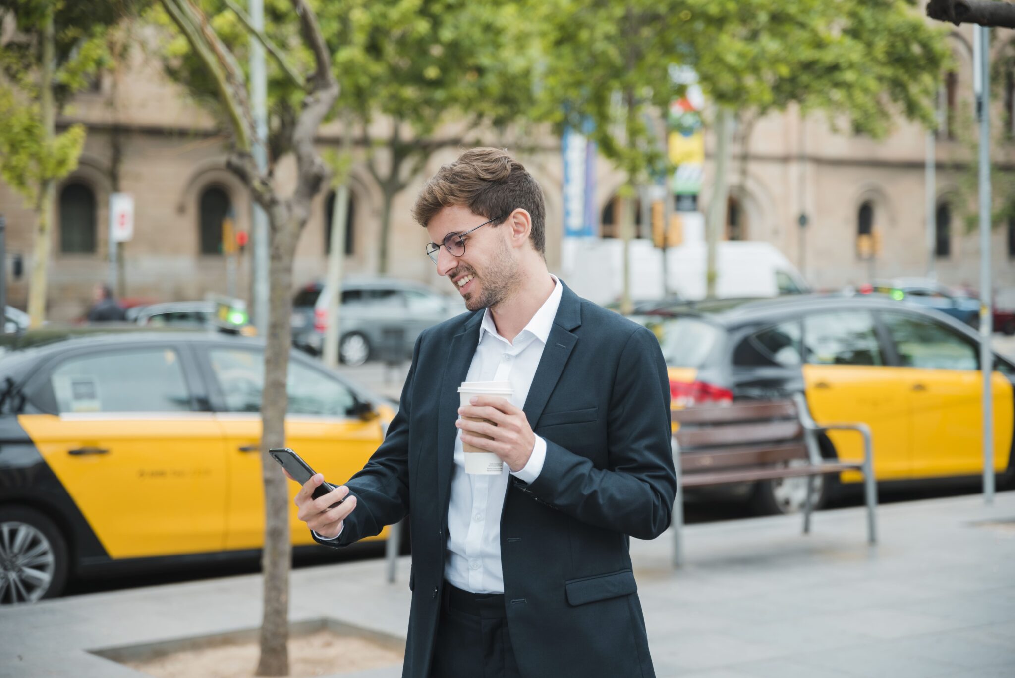 Businessman in suit checking his phone.