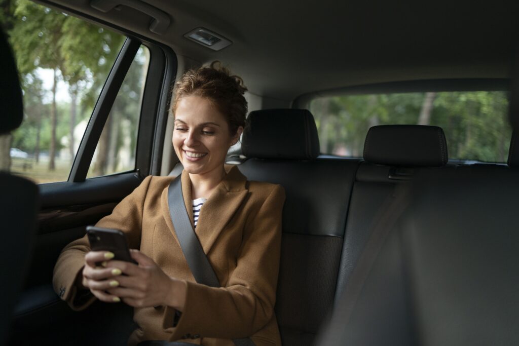 Female passenger texting in car.